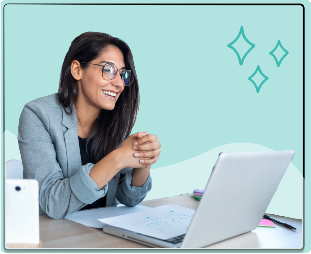 A woman sitting on a chair at a table using a laptop doing an unmoderated usability test.